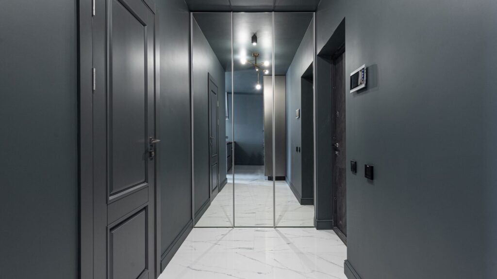 Dark corridor of numbered flat doors in a shared building