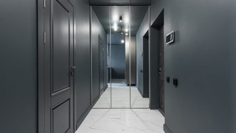 Dark corridor of numbered flat doors in a shared building