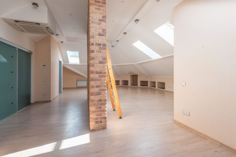 A bright empty loft room with skylights
