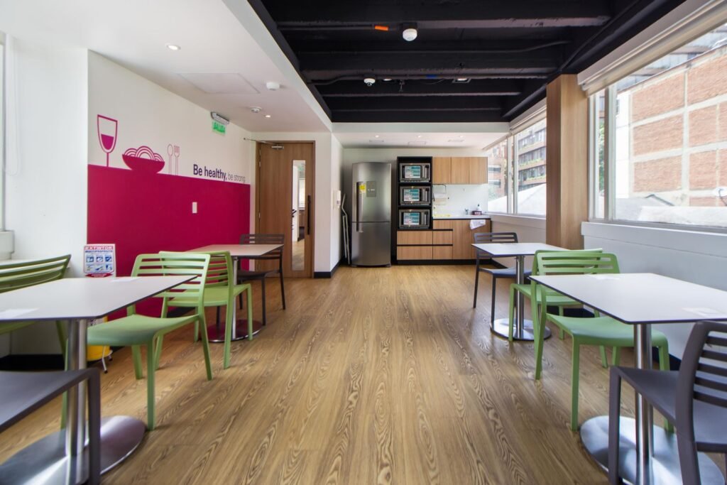 Clean office breakout area with seating and a kitchenette in a Manchester workplace