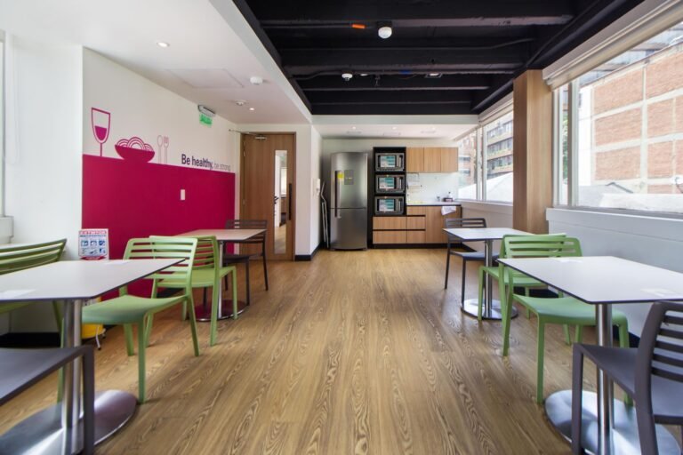 Clean office breakout area with seating and a kitchenette in a Manchester workplace