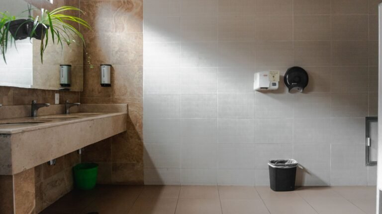 Clean commercial washroom with basins and soap dispensers in a Manchester workplace